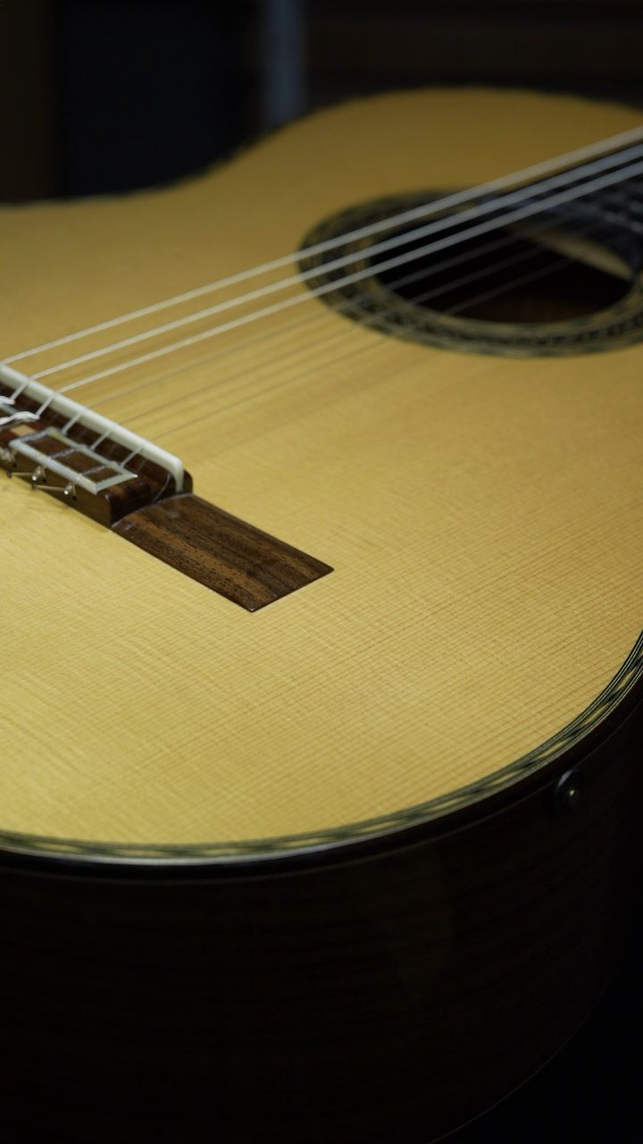 A classical guitar with the Resonare receiver mounted near the soundhole